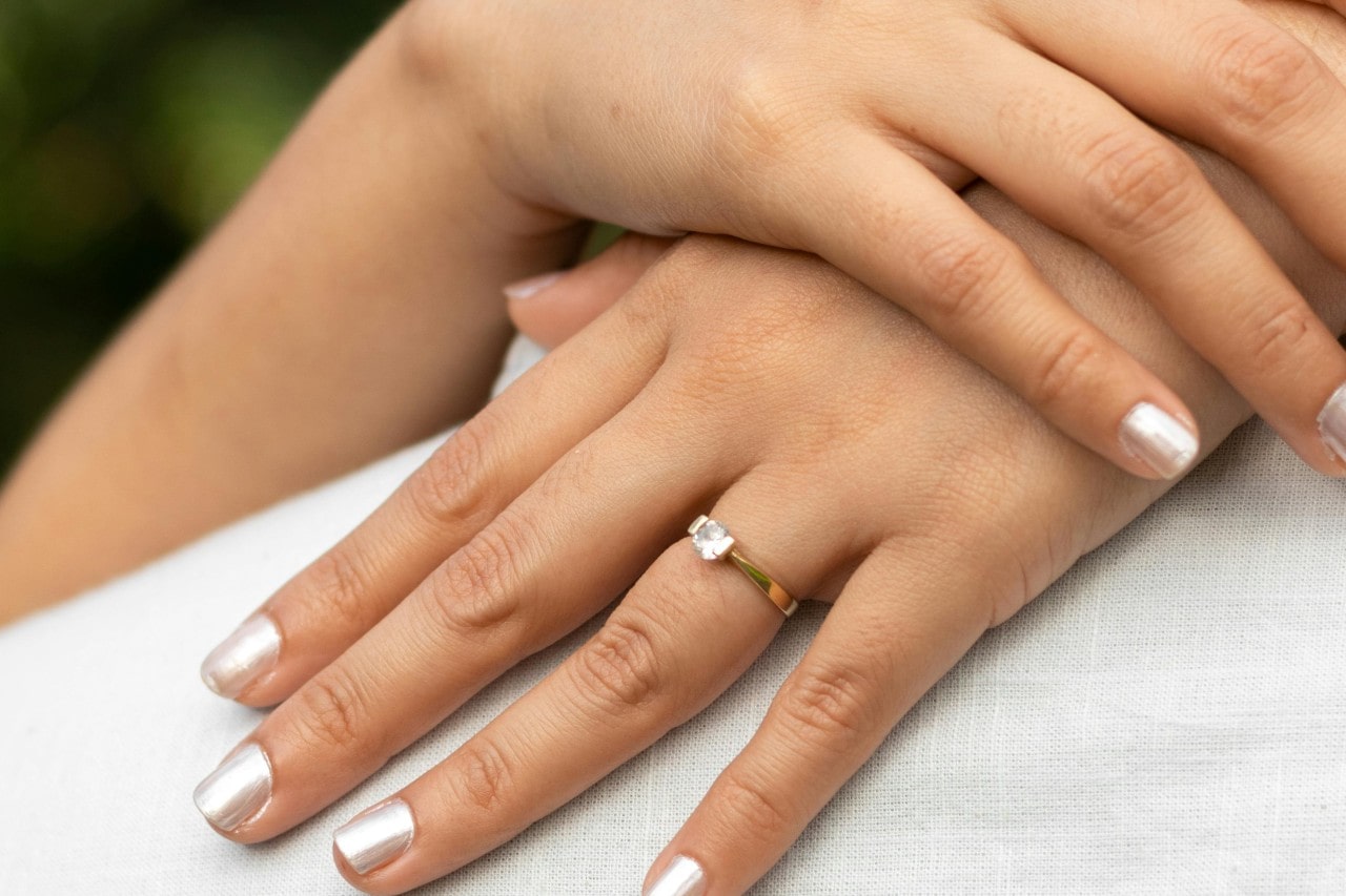 Close up of a woman's hand wearing an engagement ring Close up of a woman's hand wearing an engagement ring