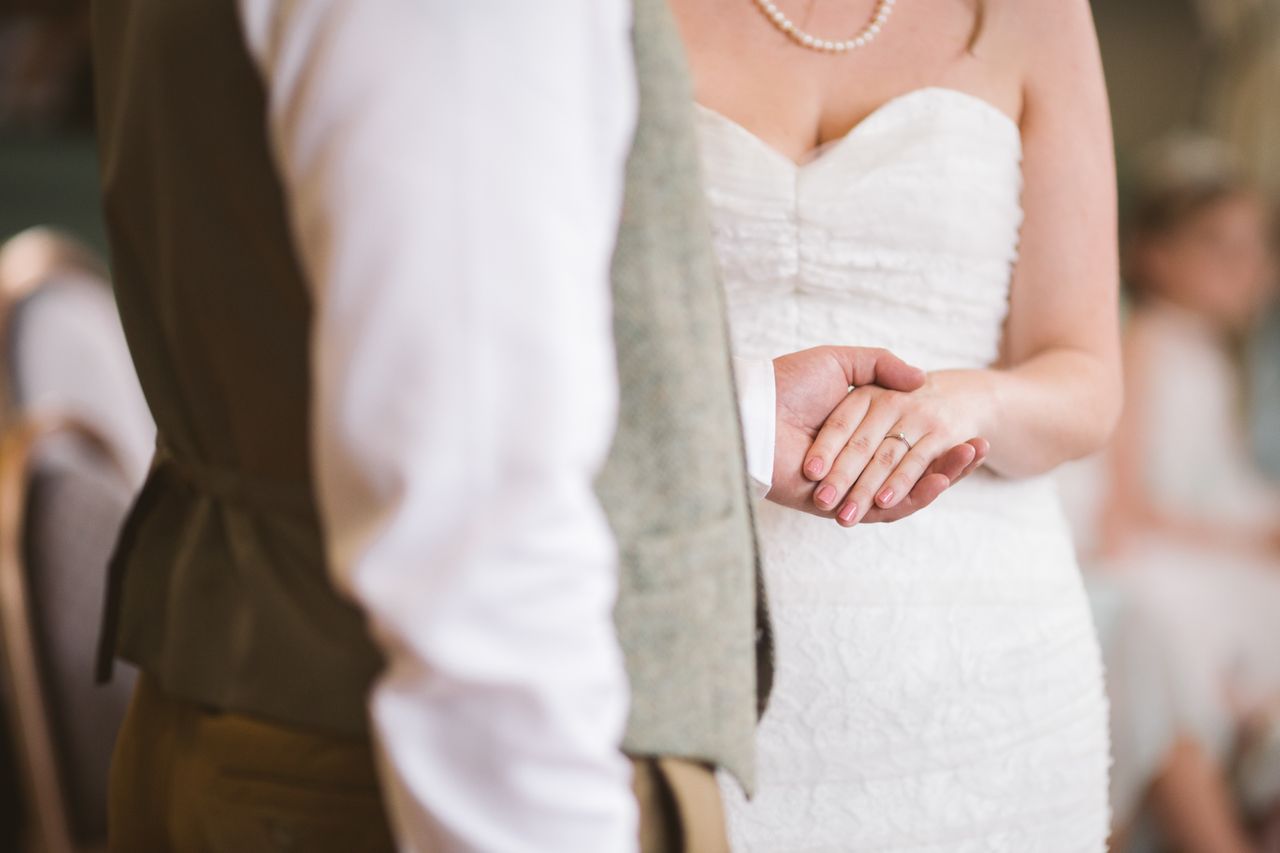 A husband holds his wife's hand to show off her wedding band A husband holds his wife's hand to show off her wedding band