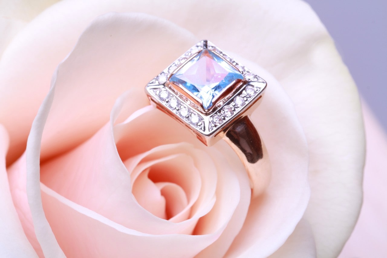 Princess cut diamond ring on a pink rose Princess cut diamond ring on a pink rose
