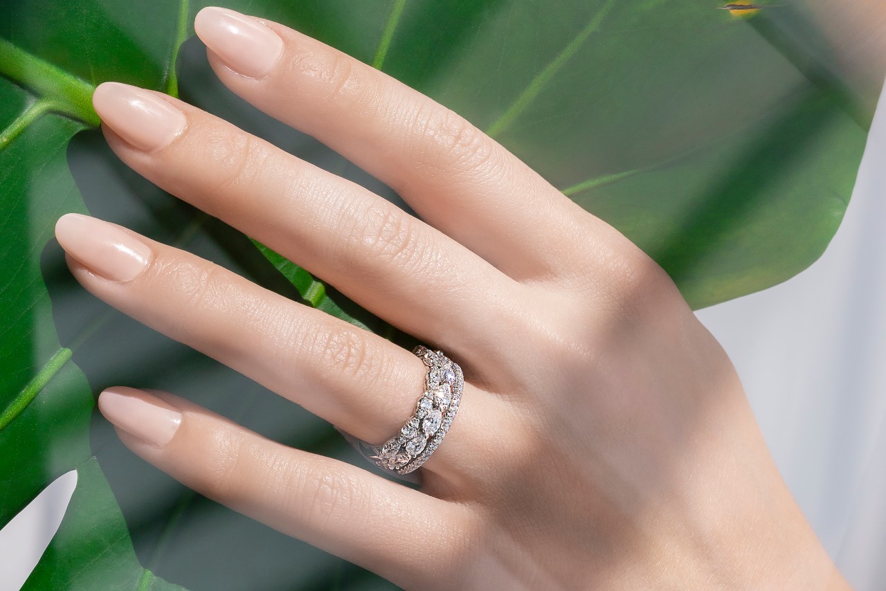 a lady’s hand wearing engagement rings by TACORI