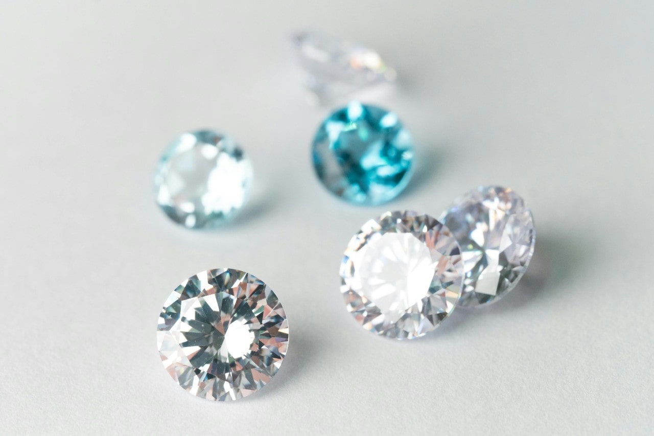 Six round-cut diamonds on a bright white background.