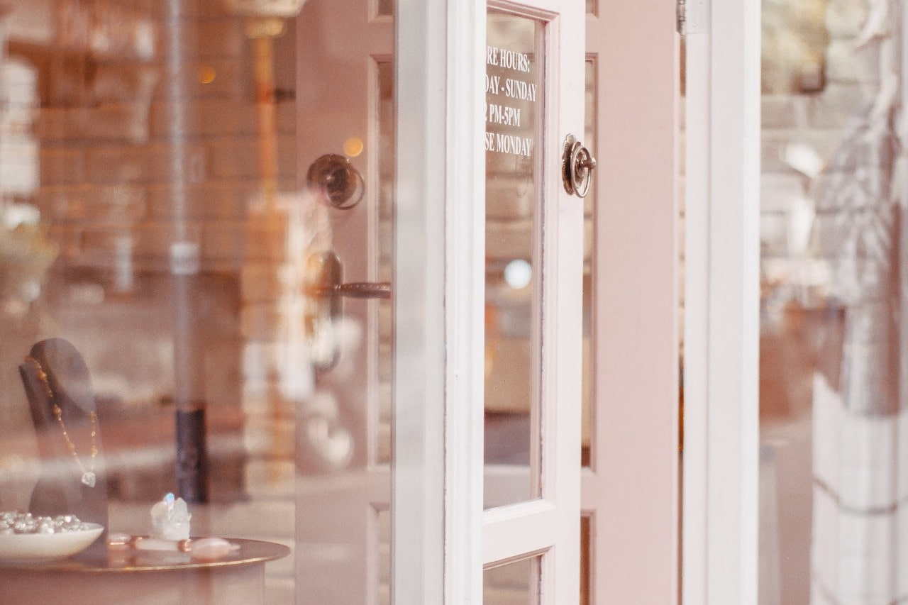 A close-up of a welcoming jewellery store, with the front door slightly ajar.