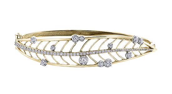 A yellow gold bangle bracelet with a leaf motif and diamond accents, available at Prestige Jewellers.